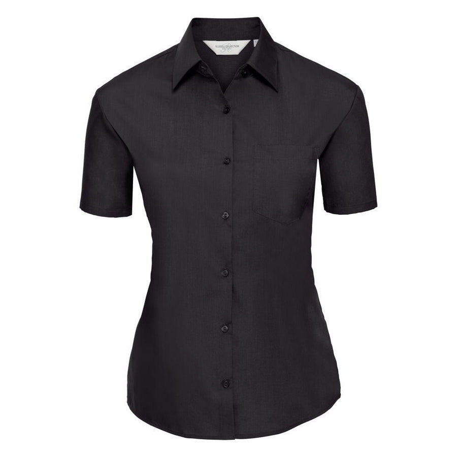 The J935F from the Russell Collection is a black, short-sleeve, button-up shirt featuring a collar and a chest pocket, displayed against a white background.