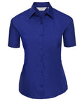 The J935F by Russell Collection is a short-sleeved, button-up royal blue shirt featuring a chest pocket, displayed on a white background.