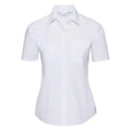 A short-sleeved, white button-up shirt from the Russell Collection J935F is displayed on a plain background. It features a pointed collar and a single breast pocket on the left side.