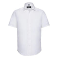 The J947M shirt from the Russell Collection is displayed against a white background. This plain white, short-sleeve button-up features a pointed collar and boasts a smooth, wrinkle-free texture for a crisp and clean appearance.