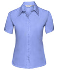 A light blue button-up, short-sleeve blouse with a pointed collar from the Russell Collection (Product Name: J957F) is displayed on a white background.