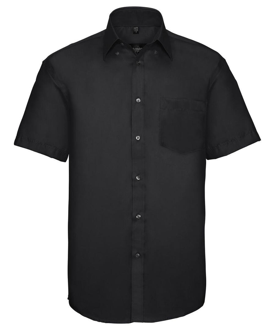 J957M by Russell Collection: A black short-sleeve button-up shirt featuring a front chest pocket, set against a white background.