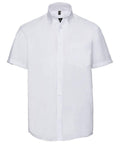 A short-sleeve white button-up shirt with a front pocket from the Russell Collection, product name J957M.