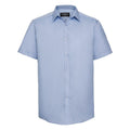 J963M short-sleeve button-up shirt in a light blue color from the Russell Collection, displayed on a white background.