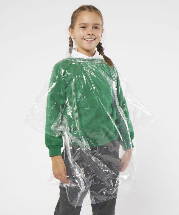 A young person with braided hair is wearing a green sweater, gray pants, and a Home & Living JB03J, standing against a plain background.