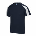 The JC003 by AWDis Just Cool is a navy blue short-sleeved T-shirt with white shoulder panels. It features a crew neck design and is showcased against a plain white background.
