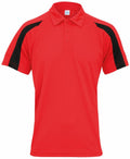 The JC043 by AWDis Just Cool is a red polo shirt with black stripes on the sleeves. It features a three-button collar and short sleeves, displayed against a white background.