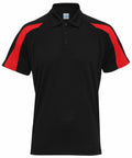 The AWDis Just Cool JC043 is a black polo shirt featuring short sleeves, a button-up collar, and a distinctive red stripe on each shoulder.