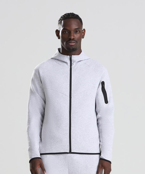 A man faces forward in a light grey AWDis Just Cool Adapt fleece zoodie with a black zip and matching trousers, set against a plain light background.