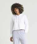 A person wearing a white AWDis Just Hoods JH016 hoodie and light gray sweatpants stands against a plain background.