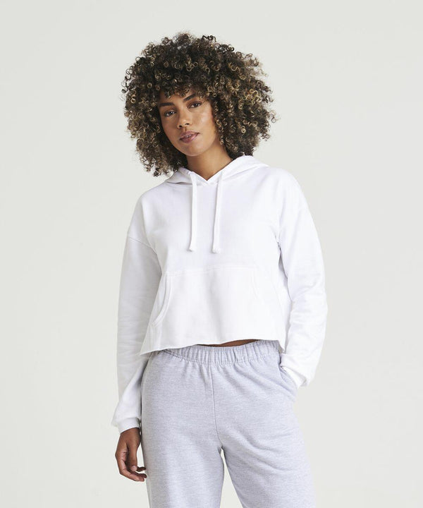 A person wearing a white AWDis Just Hoods JH016 hoodie and light gray sweatpants stands against a plain background.