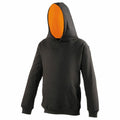 Displayed is the JH03J hoodie by AWDis Just Hoods, featuring a sleek black exterior with an orange interior. The hood is up, and you can see the front pocket. The image suggests the hoodie is being worn, though not by a person.