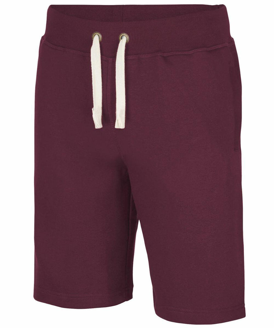 The AWDis Just Hoods JH080 shorts are maroon with white drawstrings, and they feature an elastic waistband and side pockets.