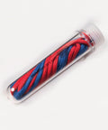A pair of red and blue JH200 shoelaces from AWDis Just Hoods neatly coiled inside a clear plastic tube with a twist-off cap.