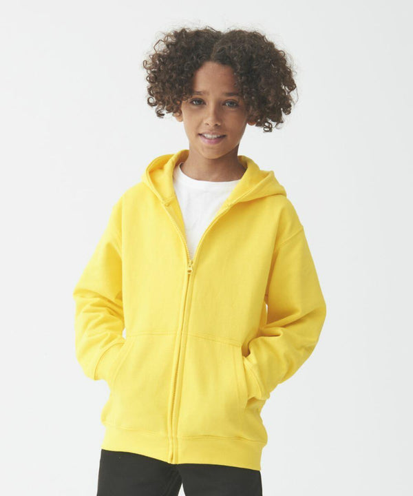A young person with curly hair wearing an AWDis Just Hoods JH50J and black pants stands against a plain white background.