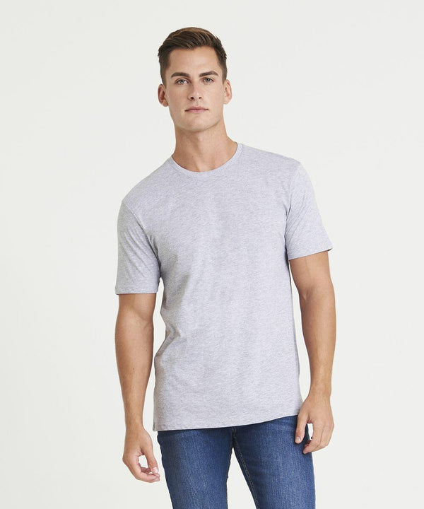 A person stands facing forward wearing an AWDis Just T's JT001 light gray T-shirt and blue jeans against a plain white background.