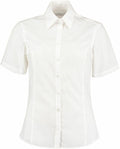 The Kustom Kit K742F, a white short-sleeved button-up shirt with a collar, is displayed against a plain background.