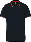 A Kariban KB250 polo shirt in navy blue, featuring red and white trim on the collar and sleeves.