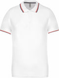 Kariban's KB250 features a white polo design with black and red accents on the collar and sleeves.
