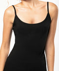 Person wearing a black Kariban KB397 spaghetti strap top. Their face is not visible in the image.