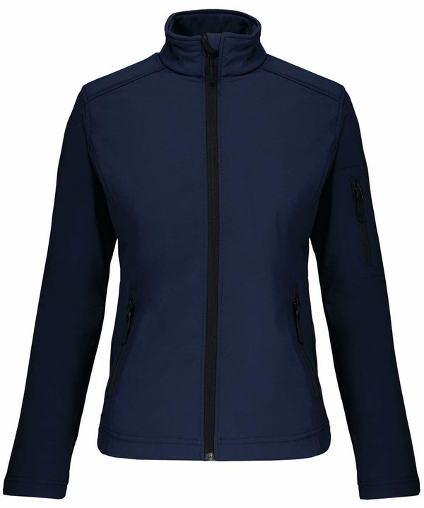 Navy blue zip-up jacket with a high collar, two zippered side pockets, and a zippered pocket on the left sleeve, displayed on a white background. The product is the KB400 by Kariban.