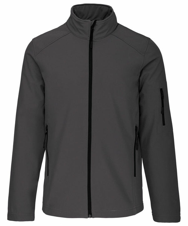 A gray Kariban KB401 zip-up jacket with a high collar and three zippered pockets, two on the sides and one on the left sleeve.