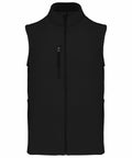 A black sleeveless vest with a front zipper and two side pockets. There is also a vertical zippered chest pocket. The vest has a high collar. Product Name: KB403, Brand Name: Kariban