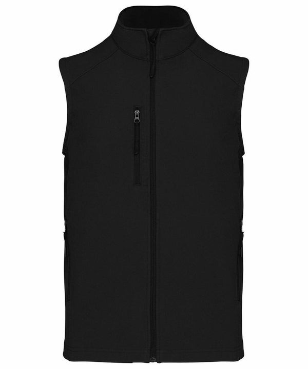 A black sleeveless vest with a front zipper and two side pockets. There is also a vertical zippered chest pocket. The vest has a high collar. Product Name: KB403, Brand Name: Kariban