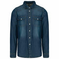The Kariban KB519 is a dark blue denim shirt featuring long sleeves, a button front, and two chest pockets.