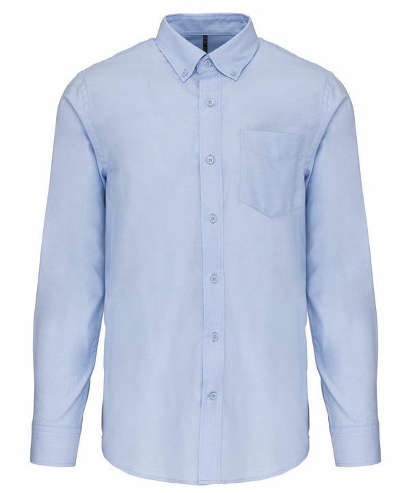 A Kariban KB533 light blue long-sleeve button-up shirt with a front pocket and a button-down collar.