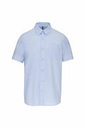 Kariban's KB535 is a light blue short-sleeve button-up shirt featuring a front pocket, showcased on a plain white background.