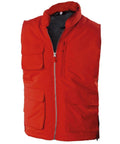 The KB615 by Kariban is a vibrant red utility vest featuring numerous pockets and a convenient front zipper.
