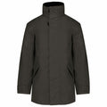 The KB677 jacket by Kariban is a dark green, long-sleeved piece featuring a high collar, a front closure, and side pockets.