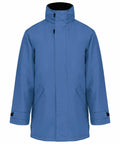 A blue, long-sleeve winter coat with a high collar and adjustable cuffs, KB677 by Kariban.