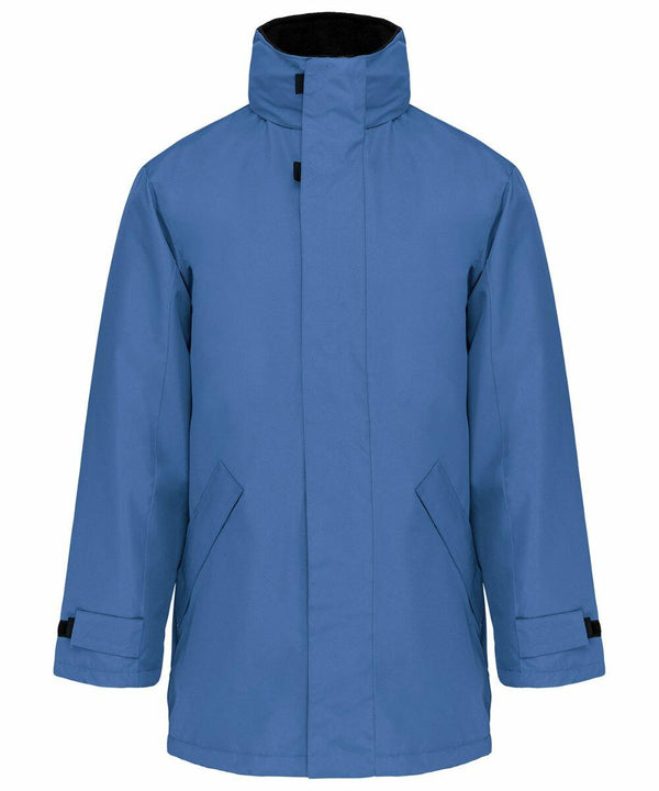 A blue, long-sleeve winter coat with a high collar and adjustable cuffs, KB677 by Kariban.