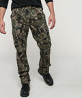 A person wearing Kariban KB744 camouflage cargo pants and black boots, showing only the lower half of the body against a plain background.