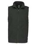 A black sleeveless vest with a front zipper closure, standing upright on a white background— the Kariban KB913.