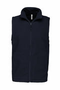 The Kariban KB913 is a black fleece vest featuring a sleeveless design, front zipper, and two side pockets.