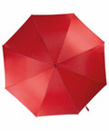 A red KiMood KI006 umbrella is fully opened, viewed from directly above. The image shows the umbrella's eight panels, with a small button at the center.