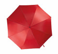 A top view image of the KI006 by KiMood, featuring a fully open, red canopy with smooth fabric and eight metal ribs radiating from a central hub. The handle is not visible.