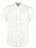 The KK102 by Kustom Kit is a short-sleeve white button-up shirt, featuring a front chest pocket and a classic collar, displayed against a plain white background.