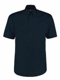 The KK109 by Kustom Kit is a dark green short-sleeved button-up shirt featuring a collar and a chest pocket.