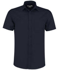 The Kustom Kit KK141 is a navy, short-sleeved button-up shirt featuring a collar and a single left chest pocket.