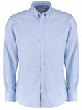Kustom Kit's KK182 is a light blue shirt featuring a classic collar, long sleeves, and white buttons.