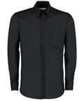 A black KK184 button-up long-sleeve shirt by Kustom Kit, featuring a collar and a chest pocket.