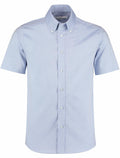 KK187 by Kustom Kit, a light blue short-sleeve button-up shirt with a collar, displayed on a plain white background.