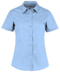 A front-facing view of the Kustom Kit KK241 shirt, featuring a light blue color, short sleeves, a button-down design, and a collar against a white background.