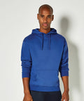 A person wearing a Kustom Kit KK333 blue hoodie and dark pants stands against a plain white background.