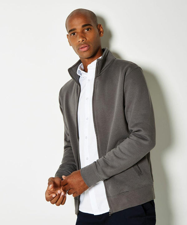 A person wearing a gray Kustom Kit KK334 zip-up jacket over a white shirt stands against a plain white background.