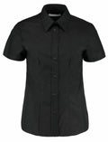 The KK360 by Kustom Kit is a short-sleeved black button-up shirt featuring a pointed collar.